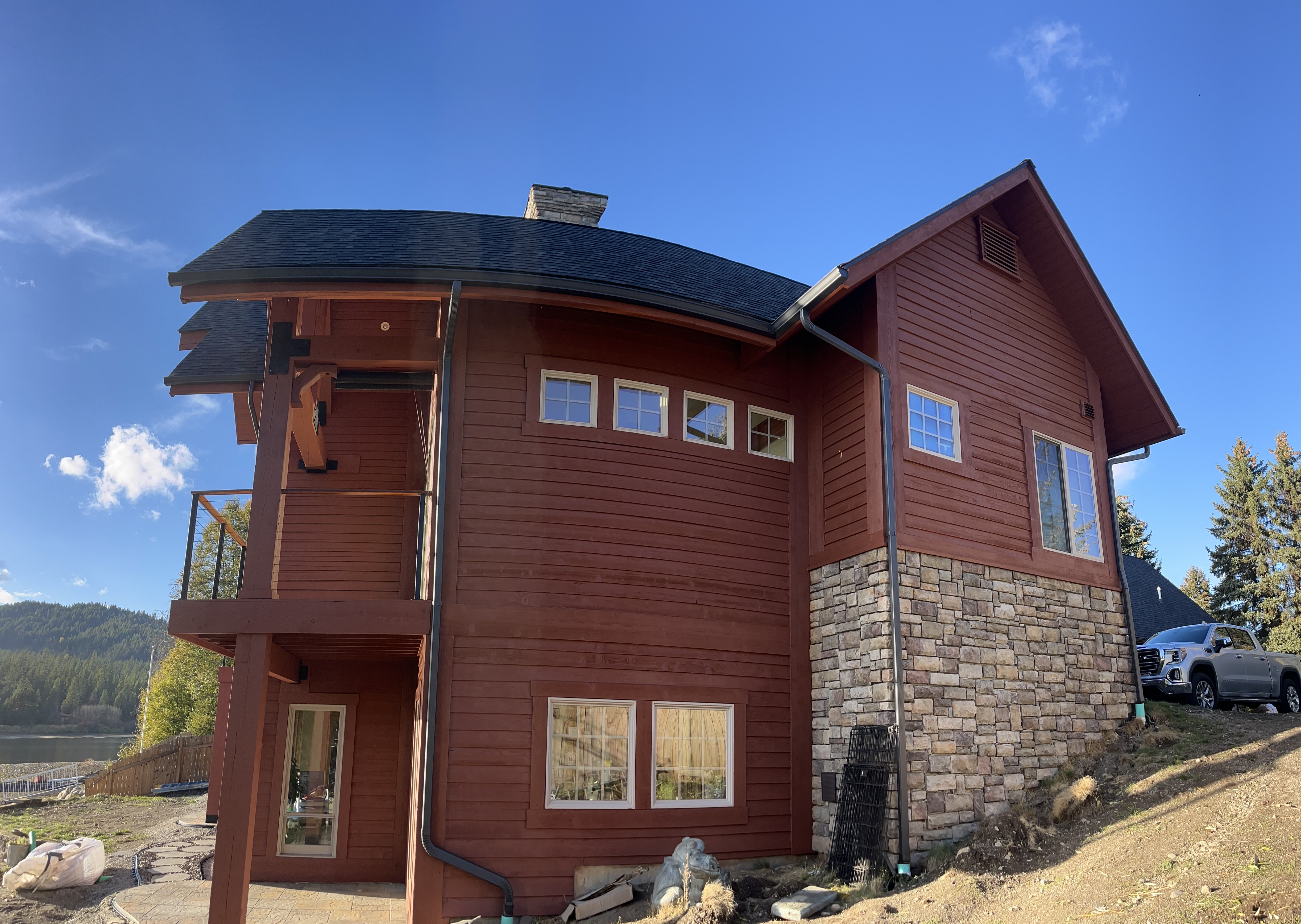 Log home side with stone base